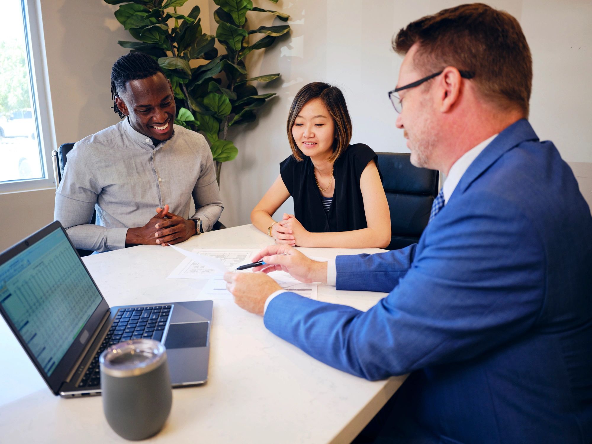 Couple meeting with an advisor in an office